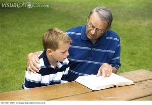 Grandpa and grandson reading the Bible